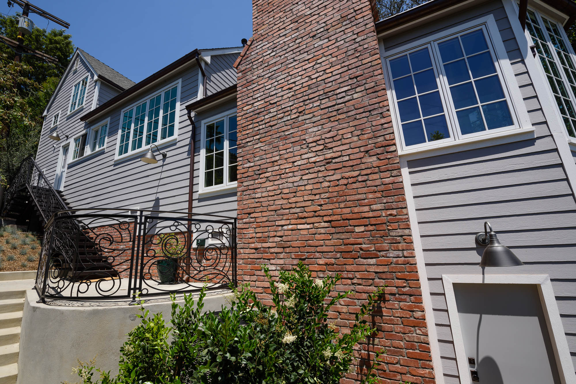  West patio leading to kitchen entrance • Chimney re-engineered using original bricks as facia. 