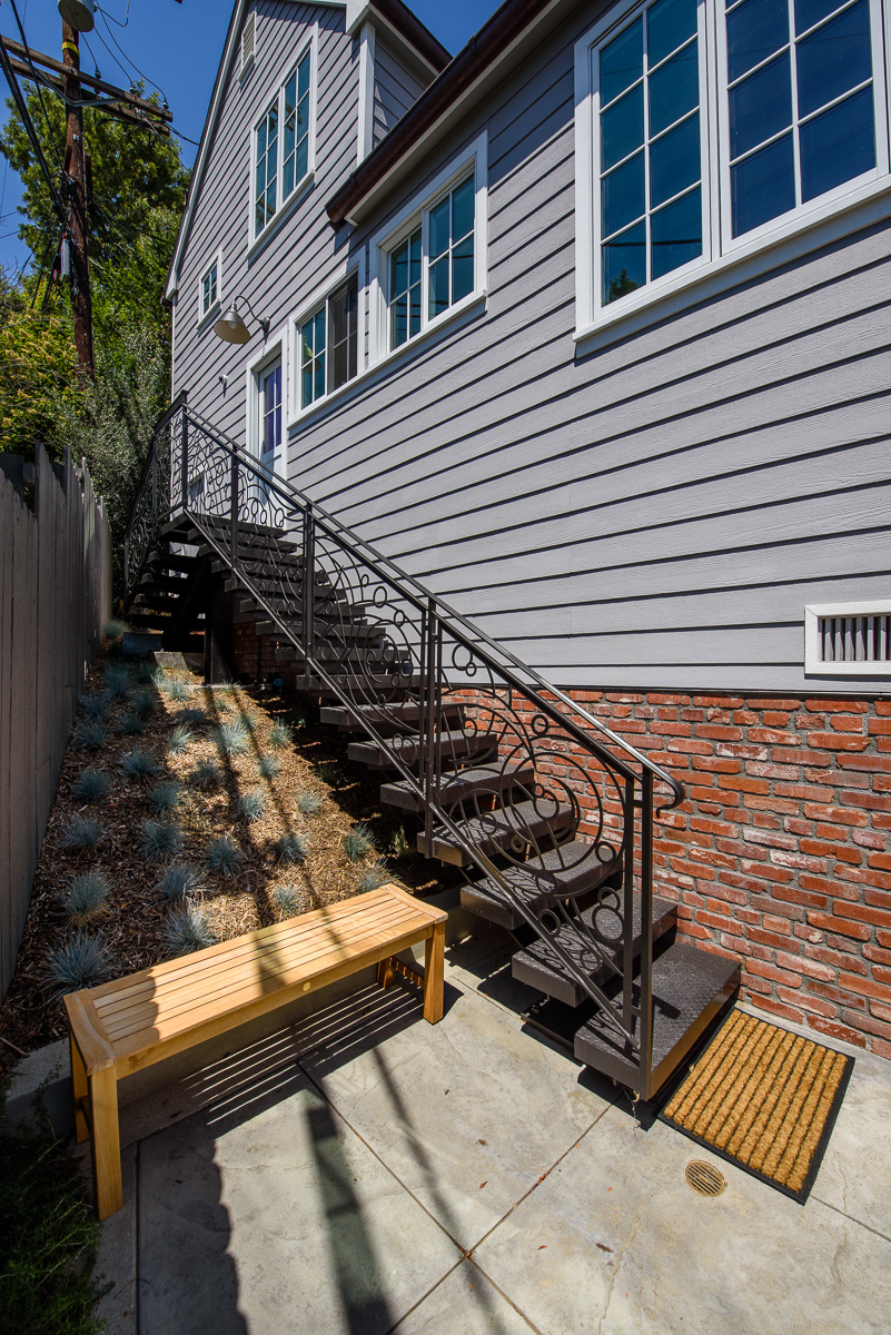  Stairs leading to kitchen with custom designed metalwork. 